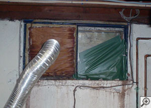 A basement window system that's rotted and  has been damaged over time in Northbridge.